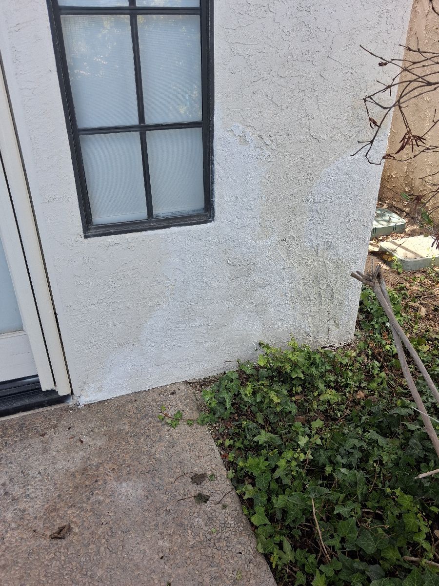 Localized stucco patch work-stage surface below an exterior window